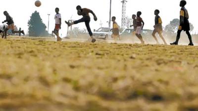 FILE - Children are seen during an informal soccer game in Soweto, South Africa, Saturday, June 20, 2009. The Confederations Cup is taking place in South Africa from June 14 to June 28. (AP Photo/Vadim Ghirda, File)
