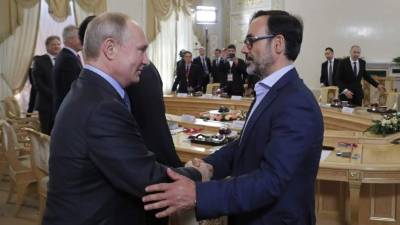 El presidente ruso, Vladímir Putin (i), saluda al presidente de la Agencia EFE, Fernando Garea, durante la reunión que mantuvo este jueves con los máximos responsables de las principales agencias de noticias del mundo para analizar la situación internacional en el marco del Foro Económico Internacional de San Petersburgo, en Rusia. EFE