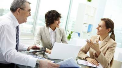 Female leader talking to her workgroup about a new profitable idea