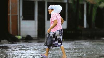 <b><span class=mln_uppercase_mln>Situación.</span></b> En San Pedro Sula, una fuerte lluvia inunda las calles.