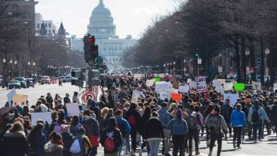 Thousands of local students march down Pennsylvania Avenue from the White House to the US Capitol during a nationwide student walkout for gun control in Washington, DC, March 14, 2018.Students across the US walked out of classes on March 14, in a nationwide call for action against gun violence following the shooting deaths last month at a Florida high school. The nationwide protest is being held one month to the day after Nikolas Cruz, a troubled 19-year-old former student at Stoneman Douglas, unleashed a hail of gunfire on his former classmates. / AFP PHOTO / SAUL LOEB