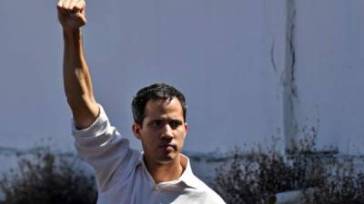 Venezuela's National Assembly president Juan Guaido gestures before a crowd of opposition supporters during an open meeting in Caraballeda, Vargas State, Venezuela, on January 13, 2019. - The president of the opposition-controlled but sidelined National Assembly was released less than an hour after being arrested by Venezuelan intelligence agents on Sunday, his wife said. Guaido had directly challenged the legitimacy of Nicolas Maduro as the president was sworn in for a second term on Thursday, calling for a transitional government ahead of new elections. (Photo by Yuri CORTEZ / AFP)