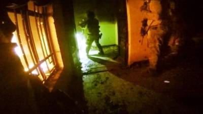 A member of the Iraqi Civil Defence disinfects an area in the capital Baghdad on March 16, 2020 amidst efforts against the spread of COVID-19 coronavirus disease. (Photo by AHMAD AL-RUBAYE / AFP)