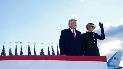 Outgoing US President Donald Trump and First Lady Melania Trump address guests at Joint Base Andrews in Maryland on January 20, 2021. - President Trump and the First Lady travel to their Mar-a-Lago golf club residence in Palm Beach, Florida, and will not attend the inauguration for President-elect Joe Biden. (Photo by ALEX EDELMAN / AFP)