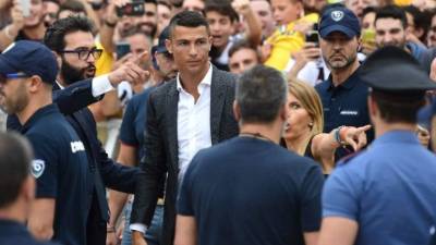 Los aficionados de la Juve recibieron calurosamente este lunes al astro portugués Cristiano Ronaldo, procedente del Real Madrid, para sellar su contrato con el campeón italiano. Cientos de hinchas le dieron la bienvenida al crack luso. FOTOS AFP Y EFE.