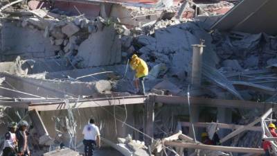 Los bomberos buscaban supervivientes entre los escombros del hospital infantil.
