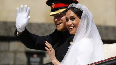 Britain's Prince Harry, Duke of Sussex (L) and Britain's Meghan Markle, Duchess of Sussex, (R) walk away from the High Altar toward the West Door to exit at the end of their wedding ceremony in St George's Chapel, Windsor Castle, in Windsor, on May 19, 2018. / AFP PHOTO / POOL / Owen Humphreys