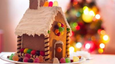 Gingerbread house with lights on dark background, xmas theme