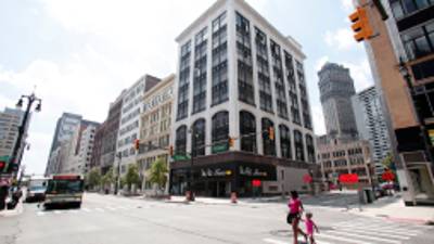 DETROIT, MI - JULY 19: A woman and young child cross the street in downtown Detroit July 19, 2013 in Detroit, Michigan. Detroit's emergency manager Kevin Orr filed for Chapter 9 bankruptcy yesterday, July 18th, making Detroit the largest city to file for bankruptcy in U.S. history. The city owes its approximately 100,000 creditors between $18 and $20 billion. Bill Pugliano/Getty Images/AFP== FOR NEWSPAPERS, INTERNET, TELCOS & TELEVISION USE ONLY ==