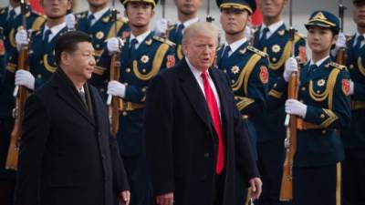 El presidente de China, Xi Jinping, y Donald Trump durante una visita del mandatario estadounidense a Pekín en 2017./Archivo AFP.