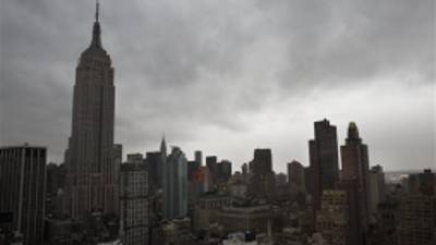 Storm clouds loom over the Empire State Building and Manhattan skyline, Monday, Oct. 29, 2012, in New York. Hurricane Sandy continued on its path Monday, forcing the shutdown of mass transit, schools and financial markets, sending coastal residents fleeing, and threatening a dangerous mix of high winds and soaking rain. (AP Photo/ John Minchillo)