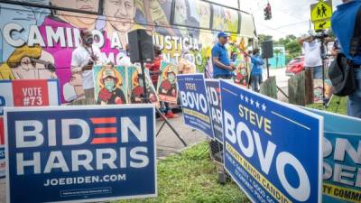 Beneficiarios del Estatus de Protección Temporal (TPS) hablan frente al autobús ''La libertad'' y rodeados de carteles electorales en Miami, Florida (EEUU). EFE