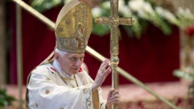 Pope Benedict XVI delivers his blessing as he leaves after celebrating a mass for the newly elected cardinals, in St.Peter's Basilica at the Vatican, Sunday, Nov. 25, 2012. On Saturday, the pontiff elevated six new cardinals who joined the elite club of churchmen who will elect his successor, bringing a more geographically diverse mix into the European-dominated College of Cardinals. (AP Photo/Andrew Medichini)