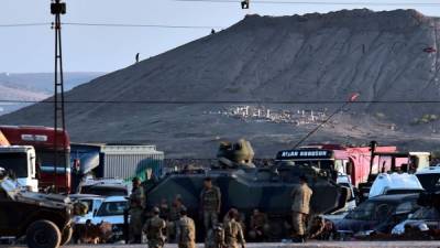 Los soldados turcos se apostan en la frontera con Siria, mientras una bandera de Isis ondea en una colina de Kobane.
