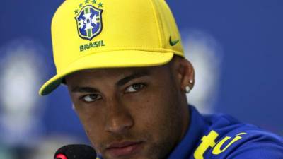 Paris Saint-Germain's Brazilian forward Neymar poses with his crutches as he arrives at his birthday party in Paris on February 4, 2019. (Photo by Thomas SAMSON / AFP)