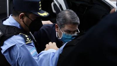 Juan Orlando Hernández siendo escoltado a la audiencia ante el juez que conoce el pedido de extradición contra el expresidente.