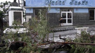 Fallen trees lie on the street after the passing of Hurricane Sandy in Santiago de Cuba, Cuba, Thursday Oct. 25, 2012. Hurricane Sandy blasted across eastern Cuba on Thursday as a potent Category 2 storm and headed for the Bahamas after causing at least two deaths in the Caribbean. (AP Photo/Franklin Reyes)