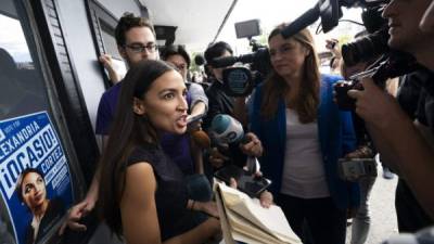 (FILES) In this file photo taken on September 22, 2018 Democratic congressional candidate Alexandria Ocasio-Cortez speaks with reporters after her general campaign kick-off rally in the Bronx borough of New York. - Alexandria Ocasio-Cortez, the Democratic superstar on the cusp of making history as the youngest woman elected to Congress, is a poster child for the left and a surge in minority women running for office. The 29-year-old, blessed with telegenic looks, charisma and bursting with youthful idealism, is both a media darling and a lightning rod for criticism. (Photo by Don EMMERT / AFP)