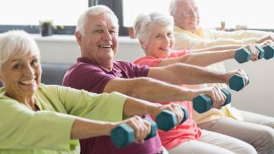 Seniors using weights in a retirement home