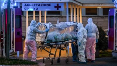 Medical workers in overalls stretch a patient under intensive care into the newly built Columbus Covid 2 temporary hospital to fight the new coronavirus infection, on March 16, 2020 at the Gemelli hospital in Rome. (Photo by ANDREAS SOLARO / AFP)