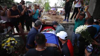 Arropado con la bandera de Olimpia, familiares dan el último adiós a Elmer Canales.
