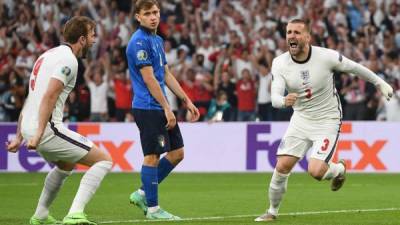 England's defender Luke Shaw (R) runs to celebrates after scoring the first goal during the UEFA EURO 2020 final football match between Italy and England at the Wembley Stadium in London on July 11, 2021. (Photo by Andy Rain / POOL / AFP)