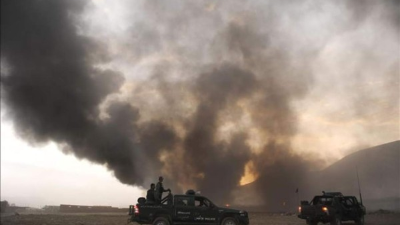 Afghan security personnel inspect the site of a car bomb attack in Lashkar Gah, capital of Helmand province on February 24, 2018.At least 23 people were killed and more than a dozen wounded in multiple suicide bombings and attacks in Afghanistan on February 24, officials said, the latest in a series of assaults in the war-torn country. / AFP PHOTO / NOOR MOHAMMAD