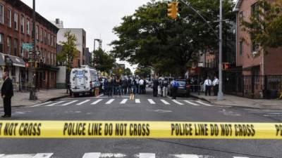 NEW YORK, NY - OCTOBER 12: A crime scene is established in front of the Triple A Aces social club on Utica Avenue on October 12, 2019 in New York City. At least four people were declared dead and three others wounded in an early morning gun fight at an illegal gambling location, according to the NYPD. Stephanie Keith/Getty Images/AFP== FOR NEWSPAPERS, INTERNET, TELCOS & TELEVISION USE ONLY ==