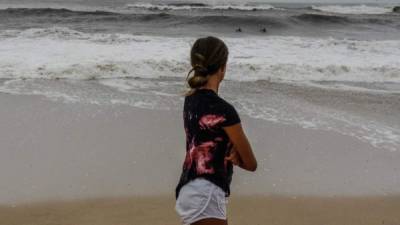 Una joven observa el oleaje cerca de la localidad de Montauk, en Long Island, Nueva York.