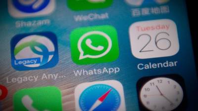 This photo illustration shows the Whatsapp application logo (C) on a smartphone screen in Beijing on September 26, 2017. Chinese authorities appear to have severely disrupted the WhatsApp messaging app in the latest step to tighten censorship as they prepare for a major Communist Party congress next month. / AFP PHOTO / NICOLAS ASFOURI