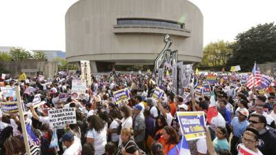 People march toward Capitol Hill in support of immigration reform, October 8, 2013 after attending a rally on The National Mall in Washington DC. Thousands called on Congress to adopt an immigration law that would allow the nation's 12 million undocumented immigrants the ability to apply for US citizenship. AFP PHOTO / Chris Kleponis