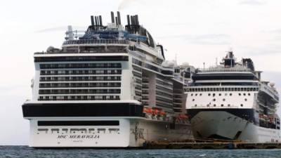 MSC Merviglia cruise ship (L) is seen in Cozumel, Mexico, on February 27, 2020. - A cruise carrying 6,000 people which was turned away by Jamaica and the Cayman Islands after a crew member tested positive for flu has docked in Mexico. (Photo by Jose CASTILLO / AFP)