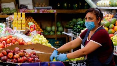 A vendor at a market in Guadalajara, Mexico, wears a face mask as a preventive measure against the spread of the new coronavirus, COVID-19, on April 1, 2020. - The global death toll from the coronavirus pandemic continued to worsen Wednesday despite unprecedented lockdowns, as the head of the United Nations sounded the alarm on what he said was humanity's worst crisis since World War II. (Photo by ULISES RUIZ / AFP)