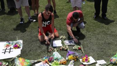 Familiares y amigos dejan flores en honor a las víctimas. AFP