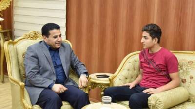 A handout picture taken from the official Facebook page of Iraq's Interior Minister Qasim al-Araji on November 30, 2017, shows al-Araji (L) meeting on August 20 with 15-year-old Iraqi Youth Osama Bin Laden at the Minister's office in Baghdad.Osama was born at the of 2001, just after the September 11 attack on the Twin Towers. He was named by his father, after the leader of al-Qaeda Osama bin Laden as a tribute.Four days before he was scheduled to change his name, Osama passed away electrcuted at his job on November 29. / AFP PHOTO / IRAQI PARLIAMENT / STRINGER / === RESTRICTED TO EDITORIAL USE - MANDATORY CREDIT 'AFP PHOTO / HO / FACEBOOK' - NO MARKETING NO ADVERTISING CAMPAIGNS - DISTRIBUTED AS A SERVICE TO CLIENTS ===