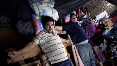 Foto del secretario general de la Federación Paraguaya de Trabajadores de Transporte Terrestre (Fepatrat), Juan Villalba Ovando (i), que lleva 10 días sin moverse de su cruz, junto a otros conductores de autobús de una línea de transporte público de Paraguay que permanecen crucificados y en huelga de hambre desde hace casi un mes. EFE