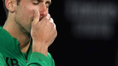 Serbia's Novak Djokovic gets emotional as he talks about Kobe Bryant after winning the men's singles quarter-final match against Canada's Milos Raonic on day nine of the Australian Open tennis tournament in Melbourne on January 28, 2020. (Photo by Greg Wood / AFP) / IMAGE RESTRICTED TO EDITORIAL USE - STRICTLY NO COMMERCIAL USE