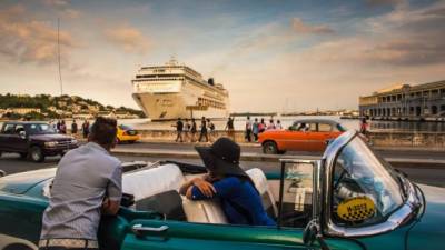 Un grupo de cubanos observa el arrivo de un crucero turístico a La Habana. Cuba se apoya en el turismo como uno de los pilares de su economía.