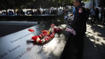 NEW YORK, NEW YORK - SEPTEMBER 11: A New York City firefighter observes a moment of silence during ceremonies at the National September 11 Memorial on September 11, 2019 in New York City. Throughout the country services are being held to remember the 2,977 people who were killed in New York, the Pentagon and in a field in rural Pennsylvania. Spencer Platt/Getty Images/AFP== FOR NEWSPAPERS, INTERNET, TELCOS & TELEVISION USE ONLY ==