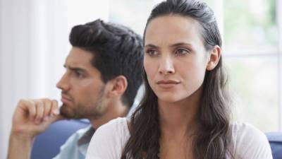 Annoyed couple not talking after argument on the couch at home in living room