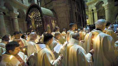 Catholic clergy walk during the Holy Thursday procession of the Washing of the Feet inside the Church of the Holy Sepulcher, traditionally believed to be the burial site of Jesus Christ, in Jerusalem's Old City Thursday April 9, 2009. (AP Photo/Bernat Armangue)