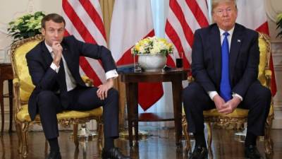 US President Donald Trump (R) and France's President Emmanuel Macron react as they talk during their meeting at Winfield House, London on December 3, 2019. - NATO leaders gather Tuesday for a summit to mark the alliance's 70th anniversary but with leaders feuding and name-calling over money and strategy, the mood is far from festive. (Photo by ludovic MARIN / POOL / AFP)