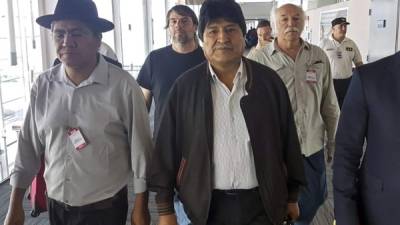 Handout photo released by the Argentina's Association of State Workers (ATE) and the Workers' Central Union of Argentina (CTA), of Bolivian ex-President Evo Morales (C) and Bolivian former Foreign Minister Diego Pary Rodriguez (L) walking upon their arrival at Ezeiza airport in Buenos Aires on December 12, 2019. - Bolivia's exiled ex-president Evo Morales arrived in Buenos Aires on Thursday where he is to seek political asylum, Argentina's Foreign Minister Felipe Sola announced. (Photo by HO / CTA / AFP) / RESTRICTED TO EDITORIAL USE - MANDATORY CREDIT 'AFP PHOTO / ATE and CTA' - NO MARKETING NO ADVERTISING CAMPAIGNS - DISTRIBUTED AS A SERVICE TO CLIENTS