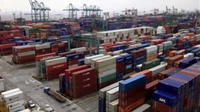 Piles of containers at Waigaoqiao Container Port are seen March 3, 2009 in Shanghai, China. The decline in China's exports accelerated in February as a slump in global demand worsened, adding to pressure on Beijing to pump up the world's third-largest economy with its massive stimulus plan and avert more job losses. (AP Photo/Eugene Hoshiko)