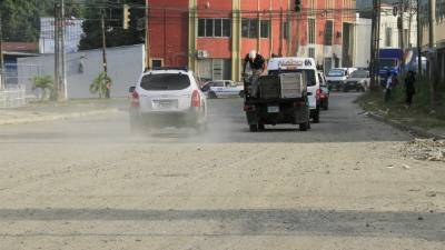 Carros pasan por la avenida y provocan “nubes” de polvo por el mal estado de la vía. Fotos: Cristina Santos