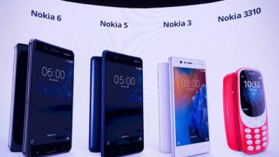 New phone models by Nokia are displayed on a screen during the presentation of the new models 'Nokia 6', 'Nokia 5', 'Nokia 3' and 'Nokia 3310' during a press conference on February 26, 2017 in Barcelona on the eve of the start of the Mobile World Congress.Phone makers will seek to seduce new buyers with even smarter Internet-connected watches and other wireless gadgets as they wrestle for dominance at the world's biggest mobile fair starting tomorrow. / AFP PHOTO / Josep Lago