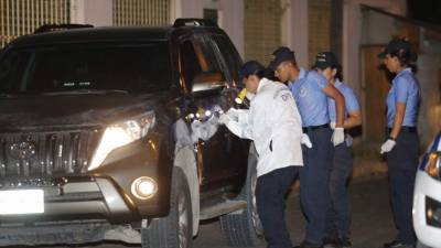 Miembros de la Policía llegaron anoche a la vivienda del depurador Jorge Machado, derecha, para iniciar las investigaciones sobre el atentado.