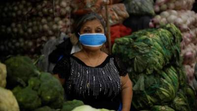 Una comerciante del Mercado de Mayoreo 'La Tiendona', la central de abastos de frutas y verduras más grande de El Salvador, usa tapabocas, este jueves, como prevención ante la pandemia del Coronavirus que este miércoles registró el primer contagio en El Salvador.