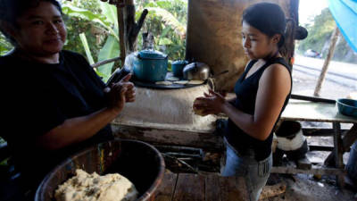 Una niña ayuda a su madre a hacer tortillas el 11 de octubre de 2013, en Siguatepeque, ubicado al norte de Honduras. EFE