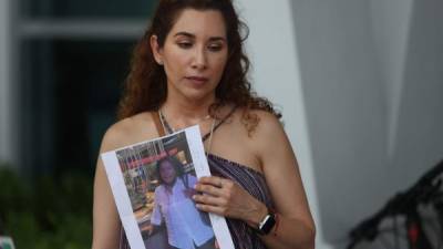 SURFSIDE, FLORIDA - JUNE 24: Luz Marina holds a picture of her aunt, Marina Azen, who she said is missing after the partial collapse of the 12-story Champlain Towers South condo tower that she was in on June 24, 2021 in Surfside, Florida. It is unknown at this time how many people were injured as search-and-rescue effort continues with rescue crews from across Miami-Dade and Broward counties. Joe Raedle/Getty Images/AFP== FOR NEWSPAPERS, INTERNET, TELCOS & TELEVISION USE ONLY ==